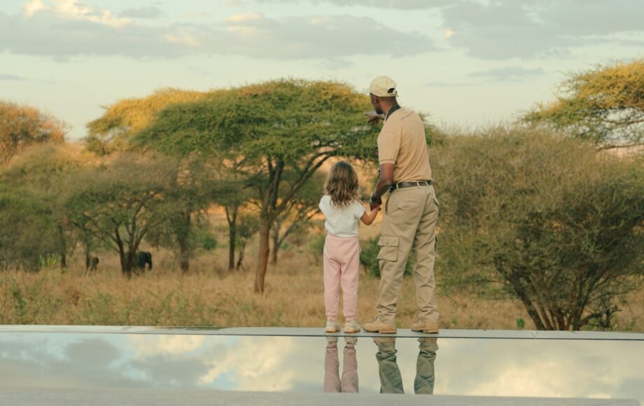 Guide showing wildlife to a child in Tanzania