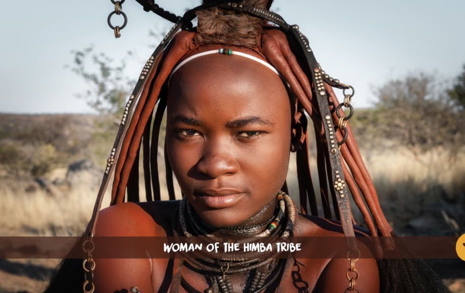 A Himba woman with ochre-red strands of hair and necklaces